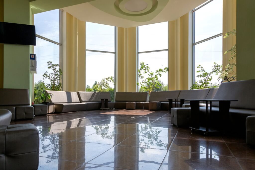 A spacious lobby with large windows, modern seating, and abundant natural light.